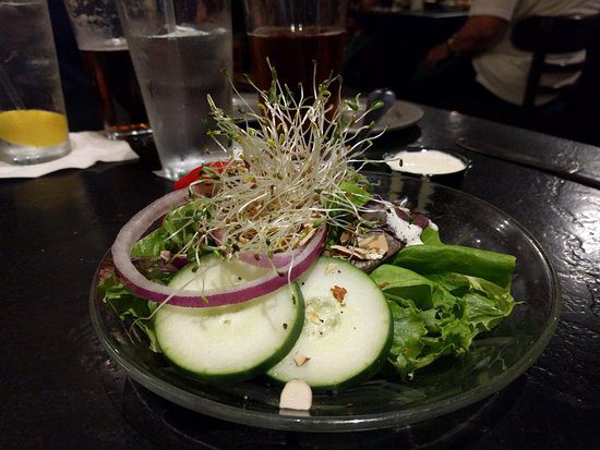 Salad served on the glass plate kept on the table